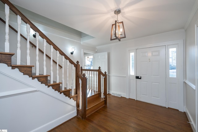 entryway featuring crown molding and dark hardwood / wood-style flooring