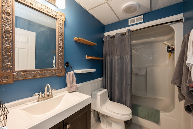 bathroom featuring a paneled ceiling, vanity, and toilet