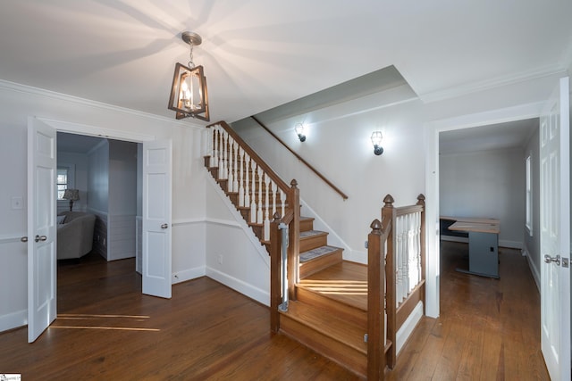 stairway with hardwood / wood-style flooring and ornamental molding