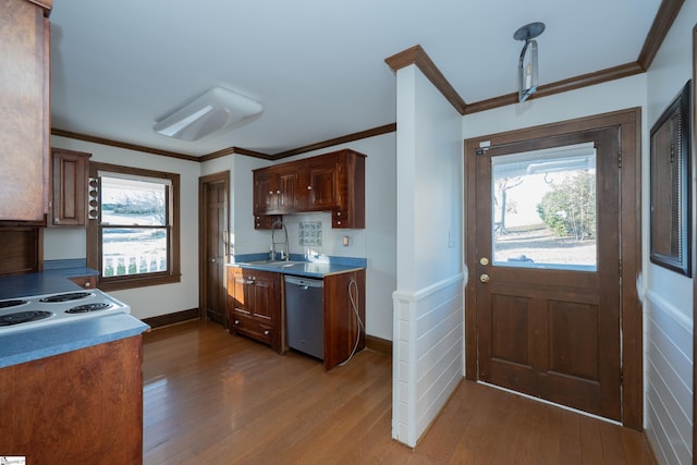 kitchen with hardwood / wood-style flooring, dishwasher, sink, and crown molding