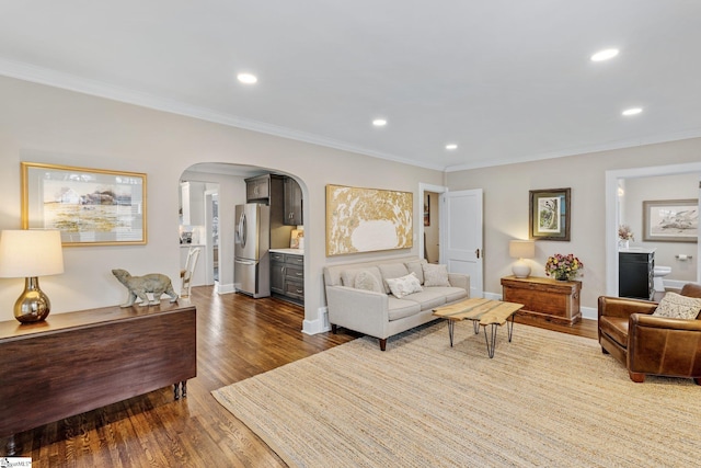 living room with hardwood / wood-style flooring and crown molding