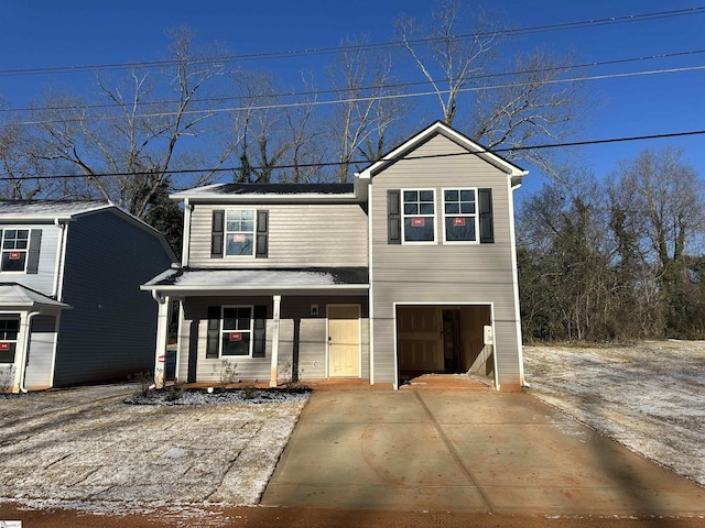 view of property featuring a garage and covered porch