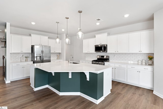 kitchen with sink, white cabinetry, and stainless steel appliances