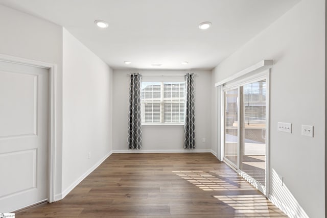 unfurnished room with hardwood / wood-style flooring and a healthy amount of sunlight