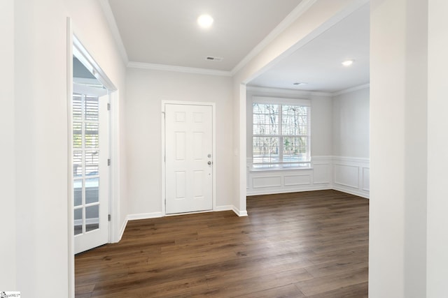 foyer entrance with dark hardwood / wood-style floors and crown molding