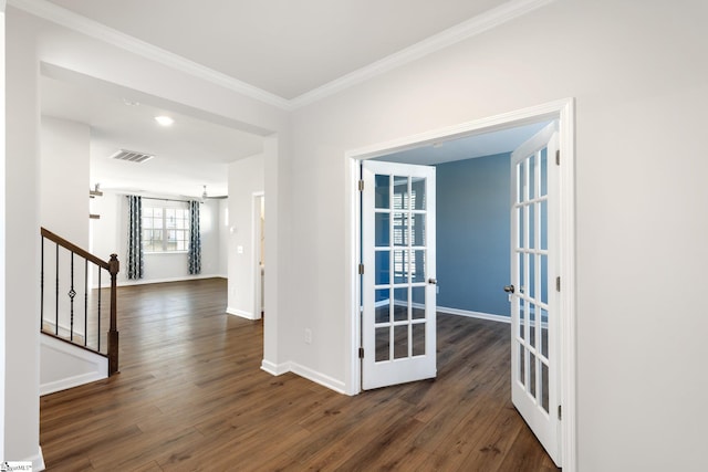 interior space with dark hardwood / wood-style flooring, ornamental molding, and french doors