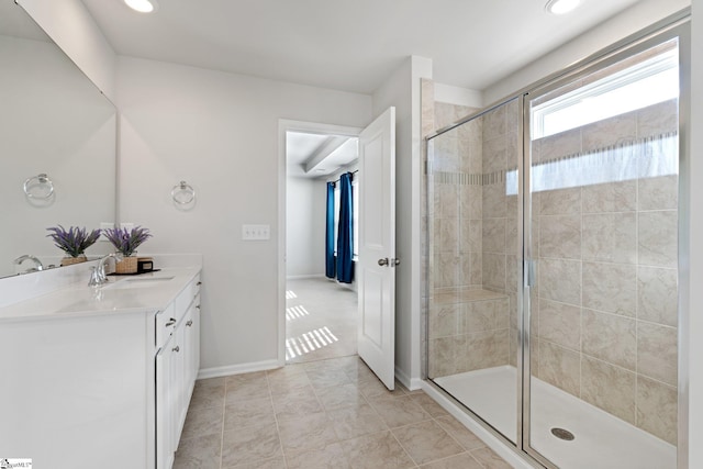 bathroom with tile patterned flooring, a shower with door, and vanity