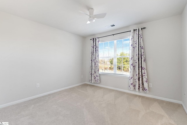 carpeted spare room with ceiling fan