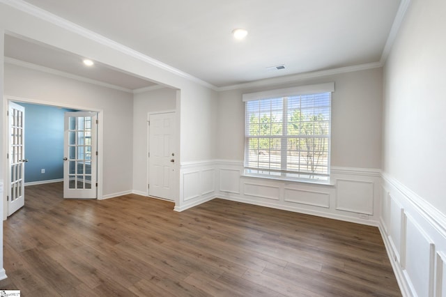 spare room featuring french doors, crown molding, and dark hardwood / wood-style floors