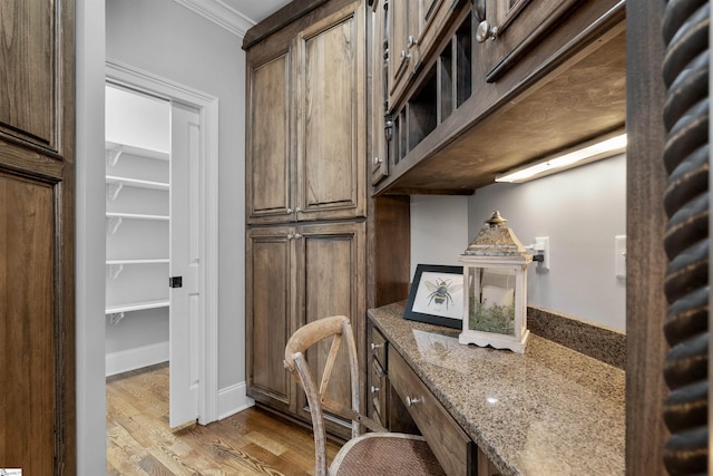 home office featuring crown molding and hardwood / wood-style floors