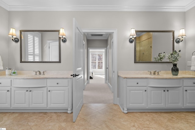 bathroom featuring vanity, a healthy amount of sunlight, and ornamental molding