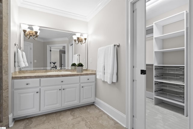 bathroom featuring crown molding, an inviting chandelier, and vanity