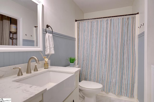 bathroom with curtained shower, toilet, tile patterned flooring, and vanity