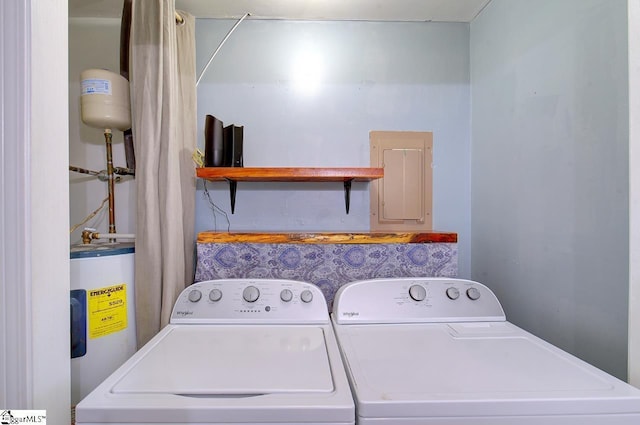 washroom featuring electric panel, water heater, and washer and dryer