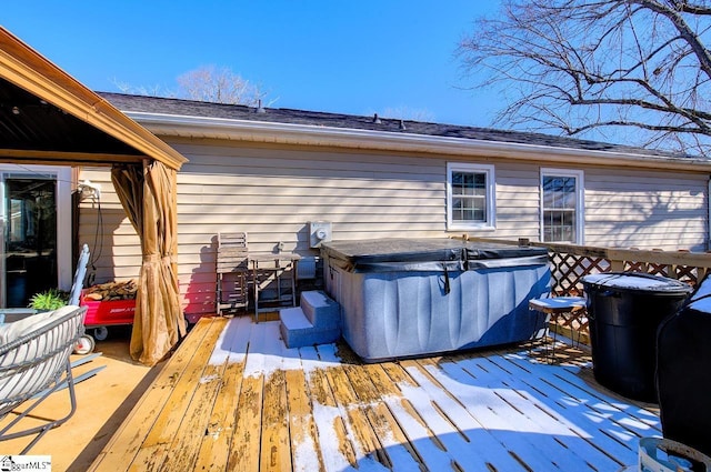 wooden terrace featuring a hot tub