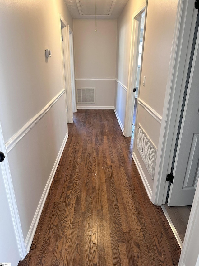 corridor with dark hardwood / wood-style flooring