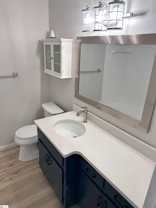 bathroom featuring vanity, toilet, and hardwood / wood-style floors