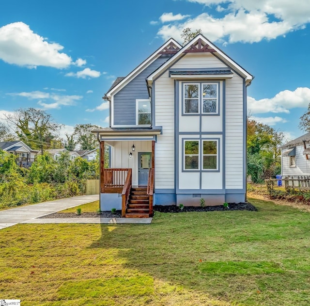 view of front of property with crawl space, driveway, and a front yard