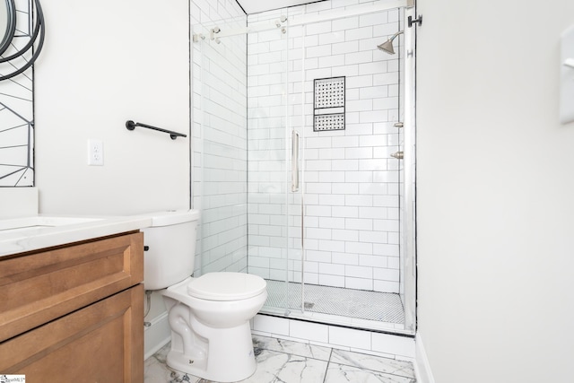 bathroom with toilet, an enclosed shower, and vanity