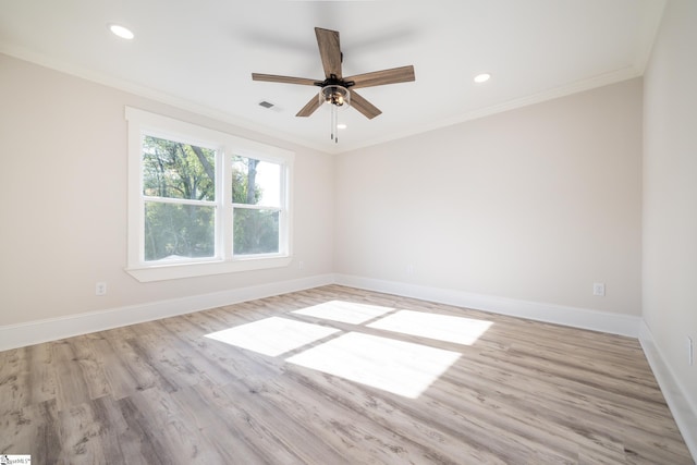 spare room featuring light hardwood / wood-style floors, ornamental molding, and ceiling fan