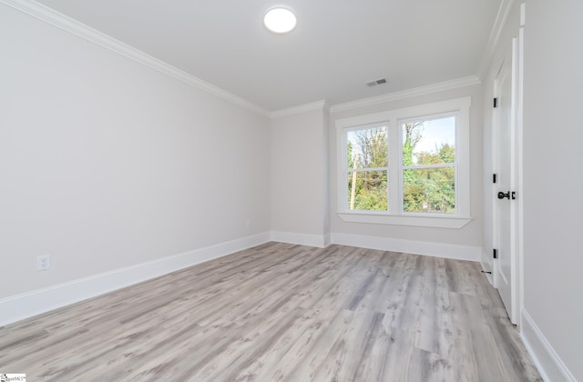 spare room with light hardwood / wood-style flooring and ornamental molding