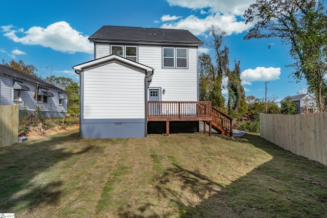 back of property with a lawn and a wooden deck