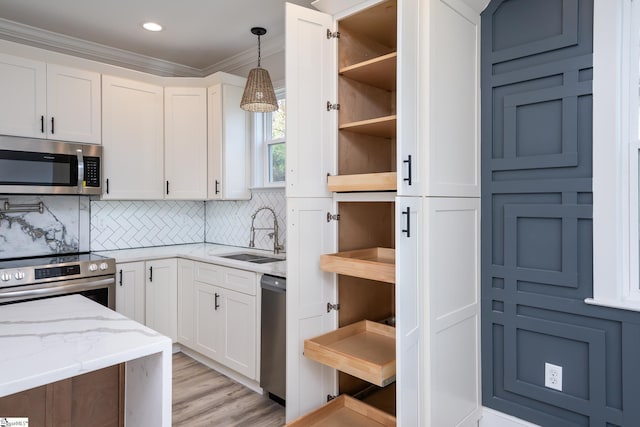 kitchen with decorative backsplash, sink, white cabinetry, and appliances with stainless steel finishes