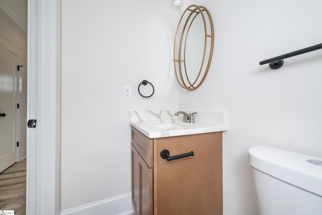 bathroom featuring toilet and vanity