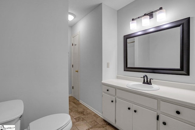 bathroom with toilet and vanity