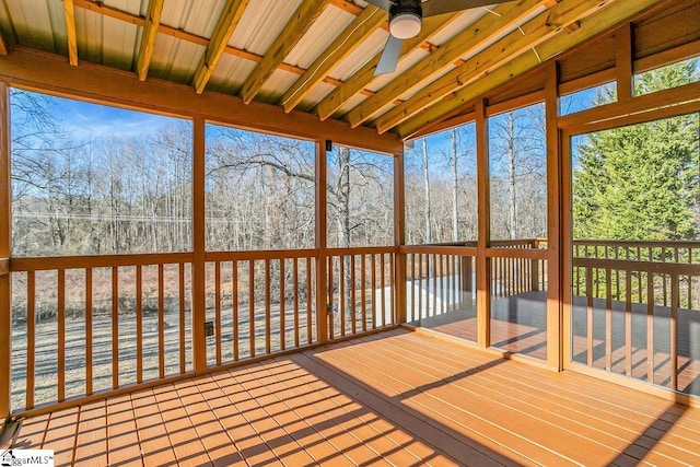 unfurnished sunroom featuring ceiling fan and vaulted ceiling