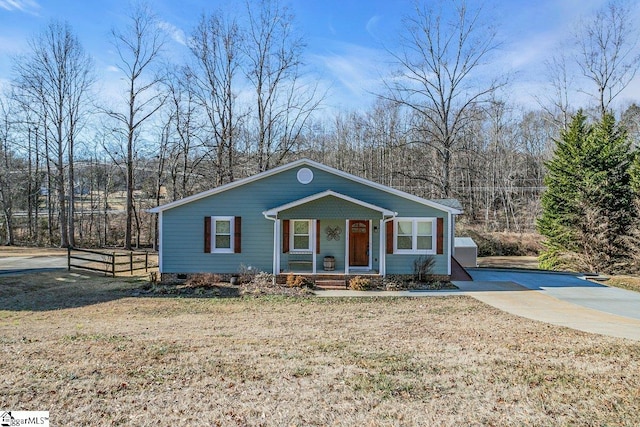 view of front of property with a porch and a front lawn