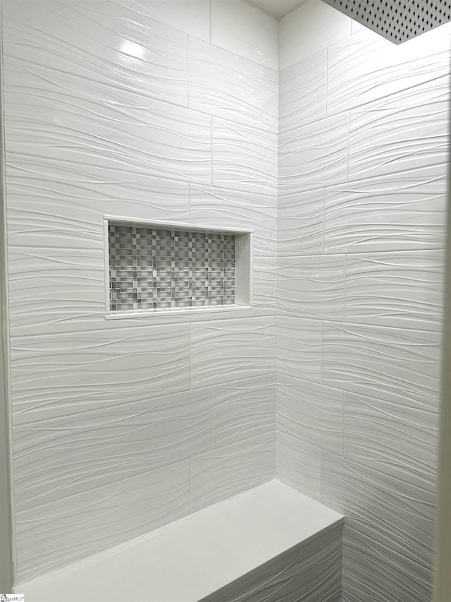 bathroom with a tile shower