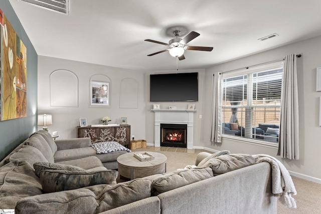 carpeted living room featuring ceiling fan