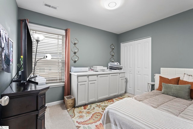 bedroom with a closet and light colored carpet