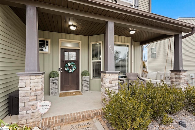 view of exterior entry featuring a porch