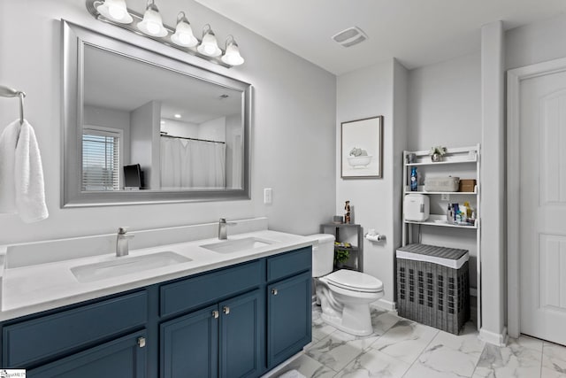 bathroom with toilet, vanity, and walk in shower