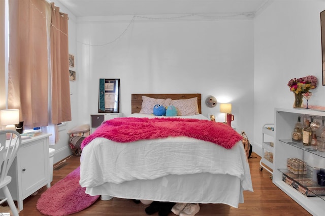 bedroom with hardwood / wood-style floors