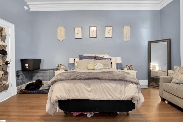 bedroom featuring ornamental molding and wood-type flooring