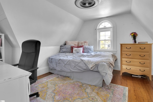 bedroom featuring vaulted ceiling and hardwood / wood-style floors