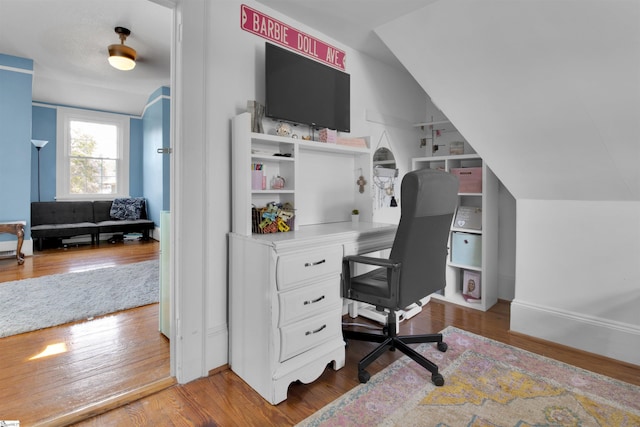 office area with hardwood / wood-style floors and lofted ceiling