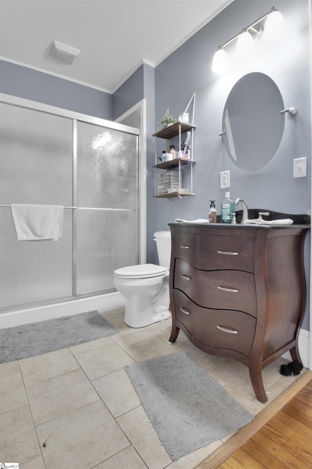 bathroom featuring a shower with door, vanity, and tile patterned flooring