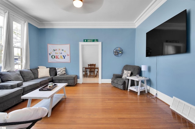 living room featuring crown molding and hardwood / wood-style flooring