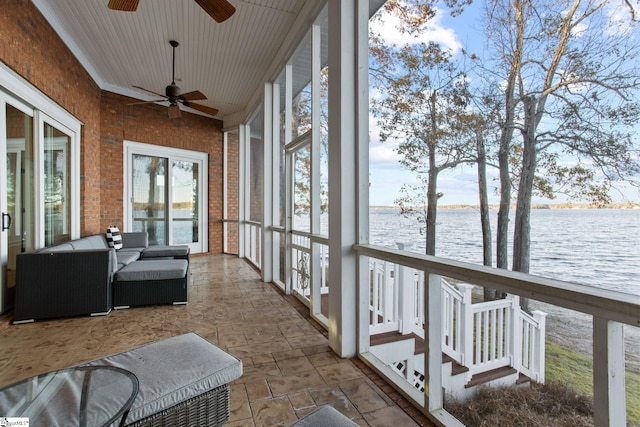 sunroom / solarium featuring a water view