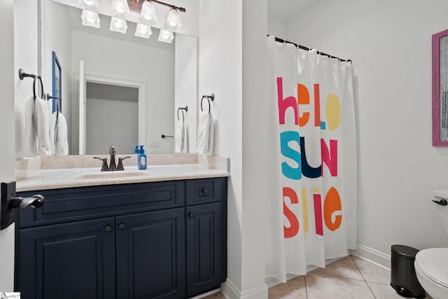 bathroom featuring vanity, toilet, and tile patterned flooring