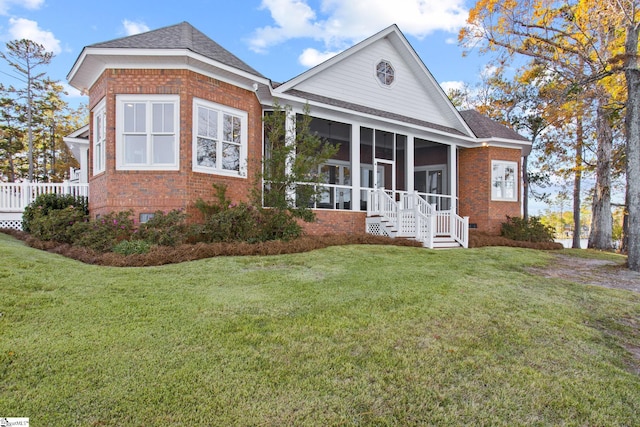 view of front of house with a front lawn and a sunroom