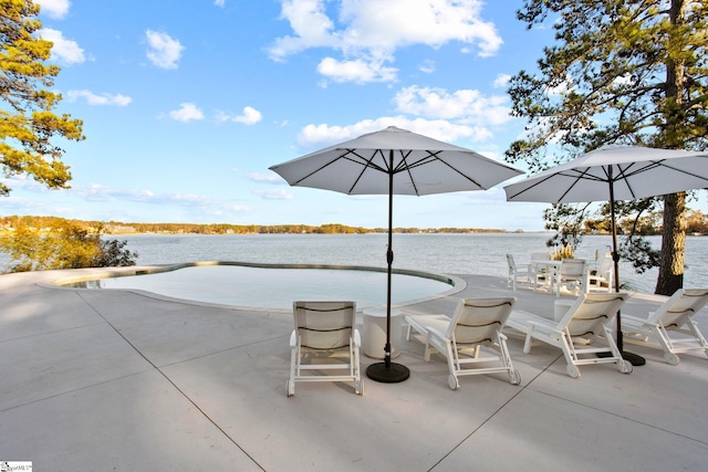 view of patio with a water view