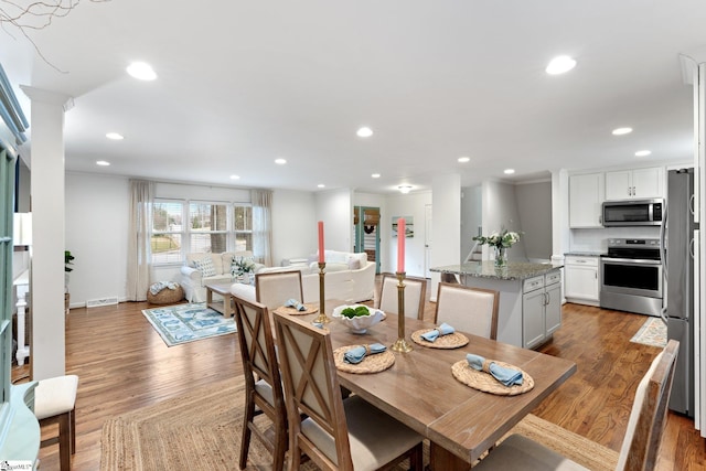 dining space with light wood-type flooring