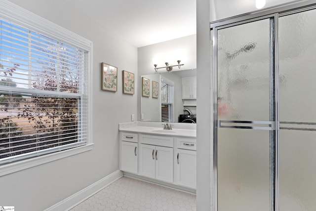 bathroom featuring walk in shower and vanity