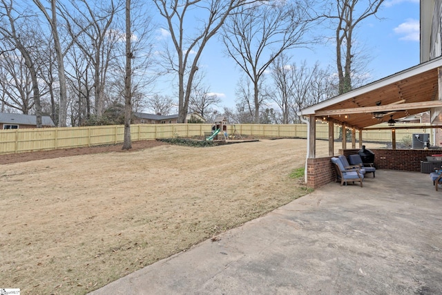 view of yard featuring a patio area, a playground, and ceiling fan