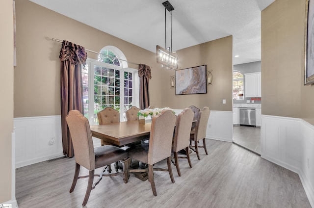 dining room featuring light hardwood / wood-style floors and a wealth of natural light